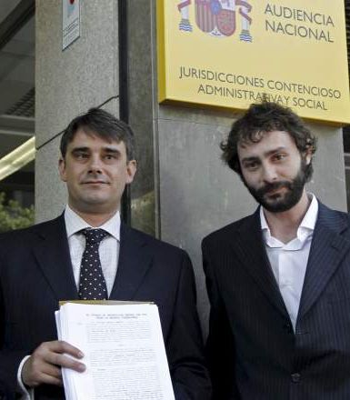 El abogado Juan Moreno, a la izquierda, junto a un representante de 15MpaRato, mostrando la querella presentada contra Rodrigo Rato en la Audiencia Nacional el 17 de julio de 2012. / J. J. Guillén (Efe)