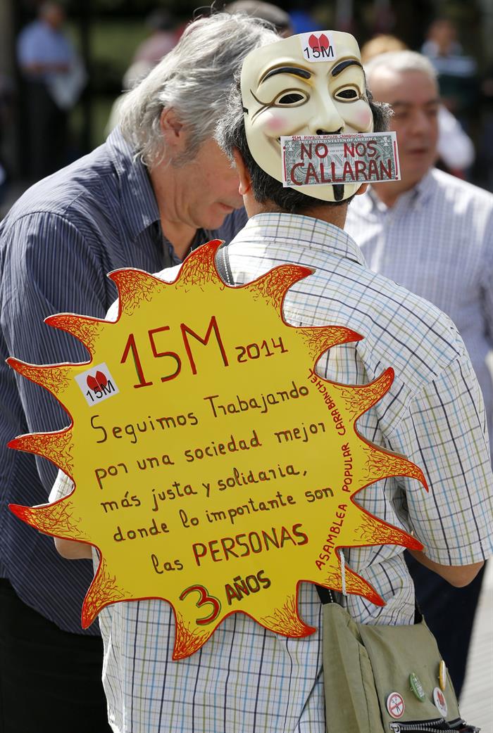 Pancarta en forma de sol de uno de los participantes en la asamblea celebrada hoy en la Puerta del Sol. / Chema Moya (Efe)
