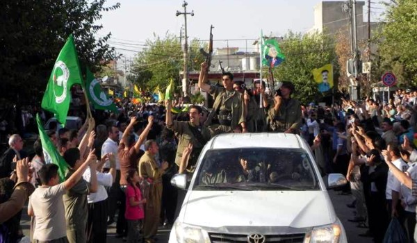 Una multitud con banderas de la UPK aclama a los guerrilleros del PKK a su paso por Kirkuk. / Firat News
