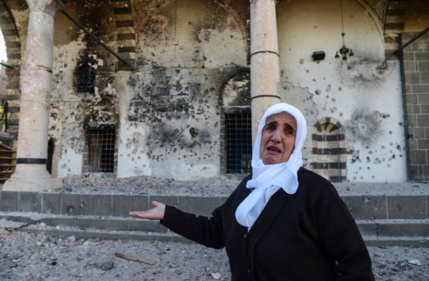 Una mujer muestra el estado en que ha quedado la mezquita de Kursunlu, del siglo XVI. / Roarmag.org