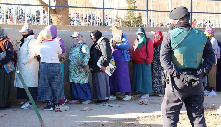 Agente GRS supervisa la fila de porteadoras en Barrio Chino - Rosa Soto